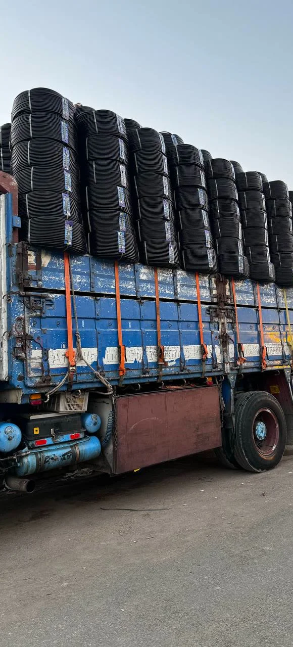 Large truck carrying bulk drip-hose coils